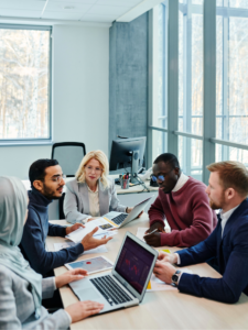 Four colleagues talking in a meeting.